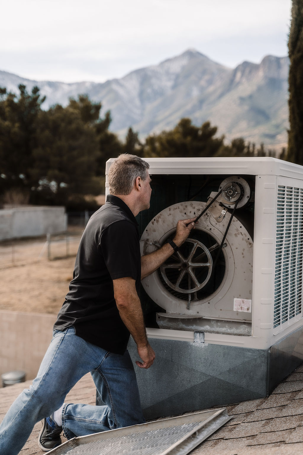 Man inspecting swamp cooler